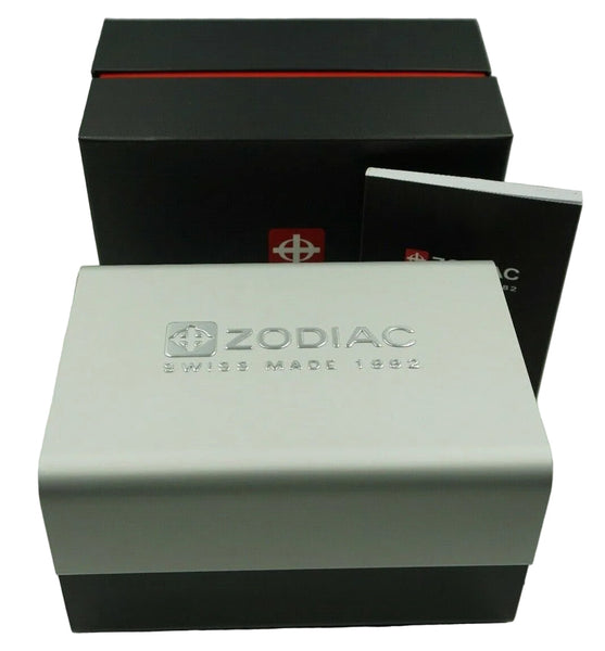 Zodiac watch packaging set featuring a white and black outer box, a black inner box with a red stripe, and a small booklet on a light gray background.